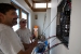 Photo of John Cartagirone and John Sharer examining electrical panel