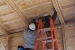Photo of students installing blocking between roof framing 
